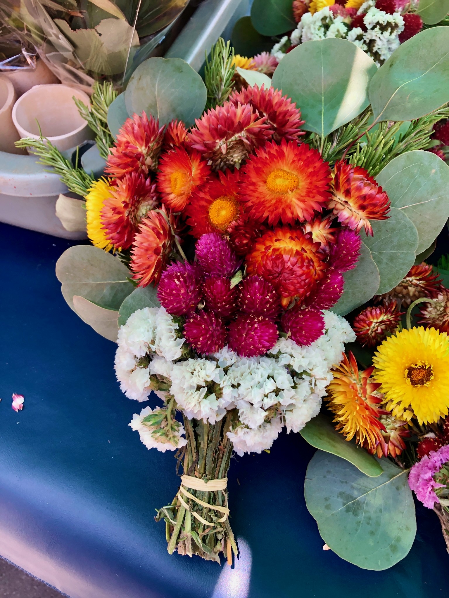 A bouquet of red-orange, gold, magenta and white flowers